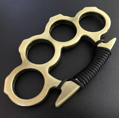 Gold knuckle duster with black cord grip angled view