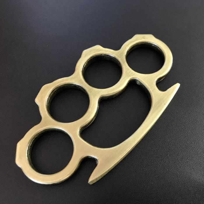 Gold outdoor knuckle duster side view on dark background