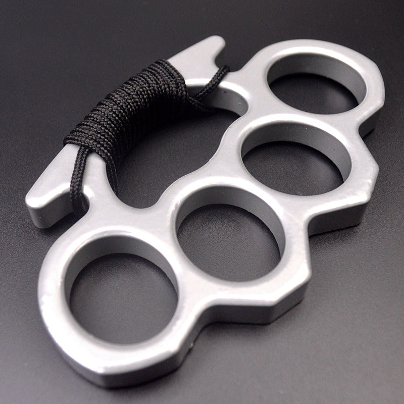 Silver outdoor knuckle duster with black paracord grip front view