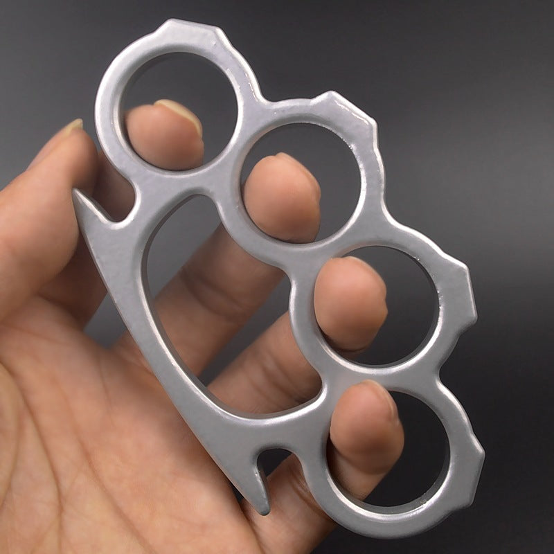 Silver outdoor knuckle duster held in hand showing polished finish