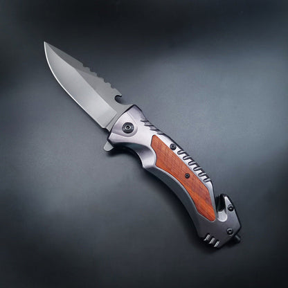 Open multifunctional folding knife with wood inlay handle on dark background