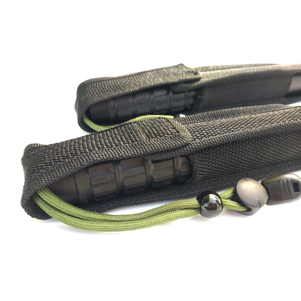 Close-up of the black nylon pouch with the green cord and bead toggle outside