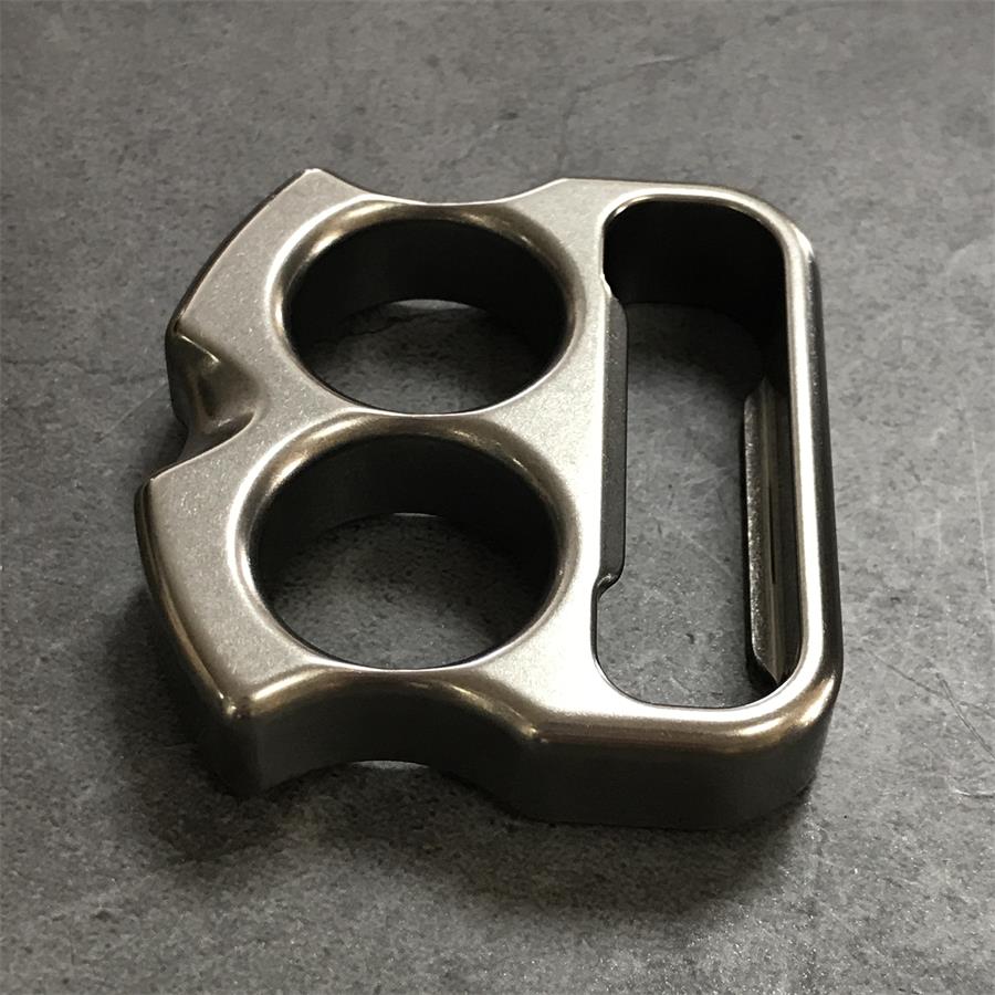 Oblique grip view of titanium duster showing chamfered side wall