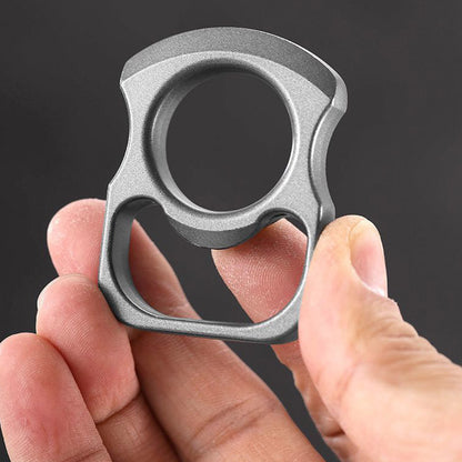Fingers gripping the grey zinc alloy opener tool in a close view of the matte finish