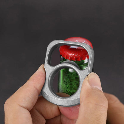 Two zinc alloy opener tools on stone showing the front face and the angled side thickness