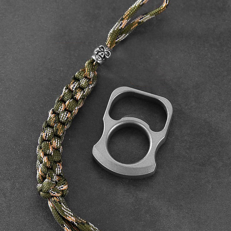 Hands prying a red crown cap from a green bottle with the zinc alloy opener ring tool