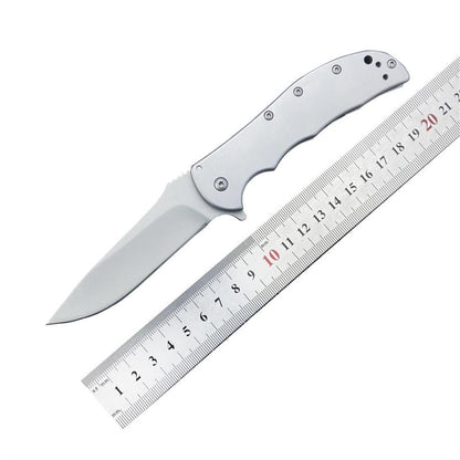 Open pocket knife measured against a metal ruler showing its full length on a white background
