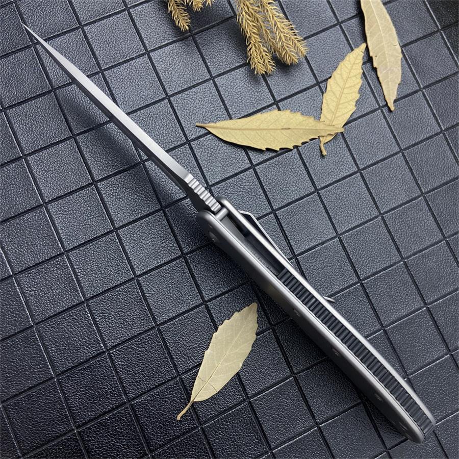 Slim side profile of the open knife showing the blade spine and jimping above the steel handle