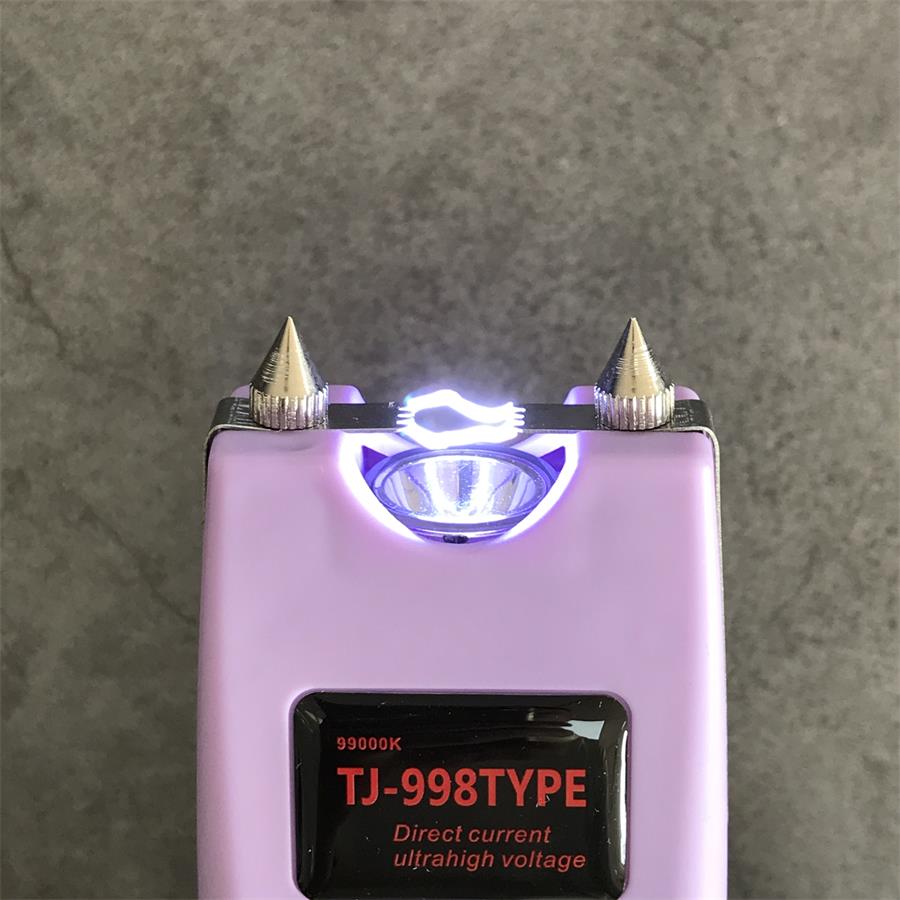 Top close-up of the light purple unit showing two cone electrode pins on a chrome band around a lit LED reflector