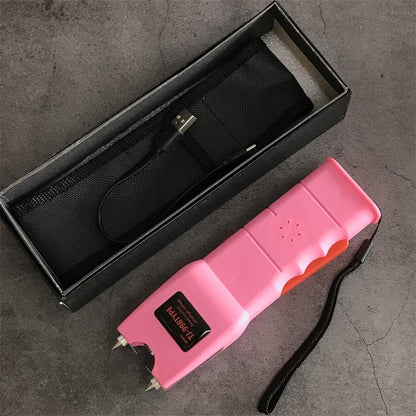 Open black retail box holding a black nylon holster and USB charging cable beside the pink 998 unit with its wrist lanyard