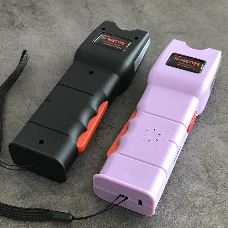 Black and light purple units standing upright with the purple base showing the charging port and the wrist lanyard loop