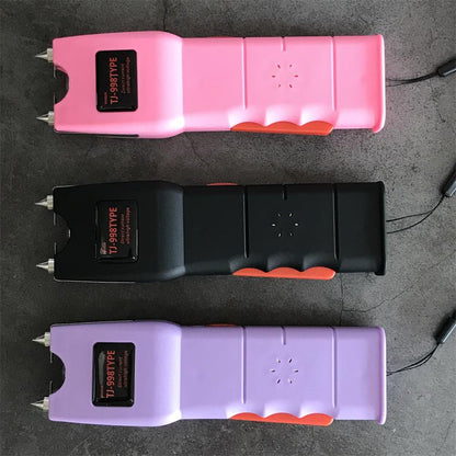 Pink, black and light purple units flat side by side showing the sunburst speaker perforation cluster and wavy orange grips