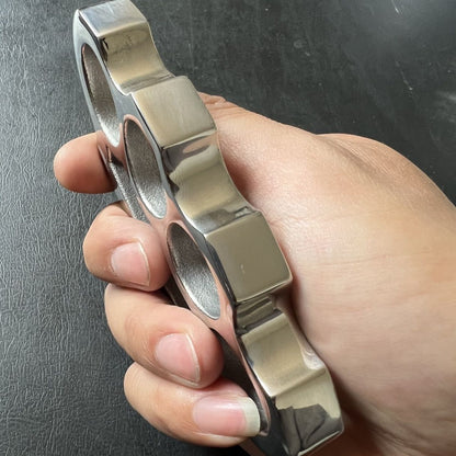 Side thickness view of the stainless steel parachute rope knuckle duster held in a hand.