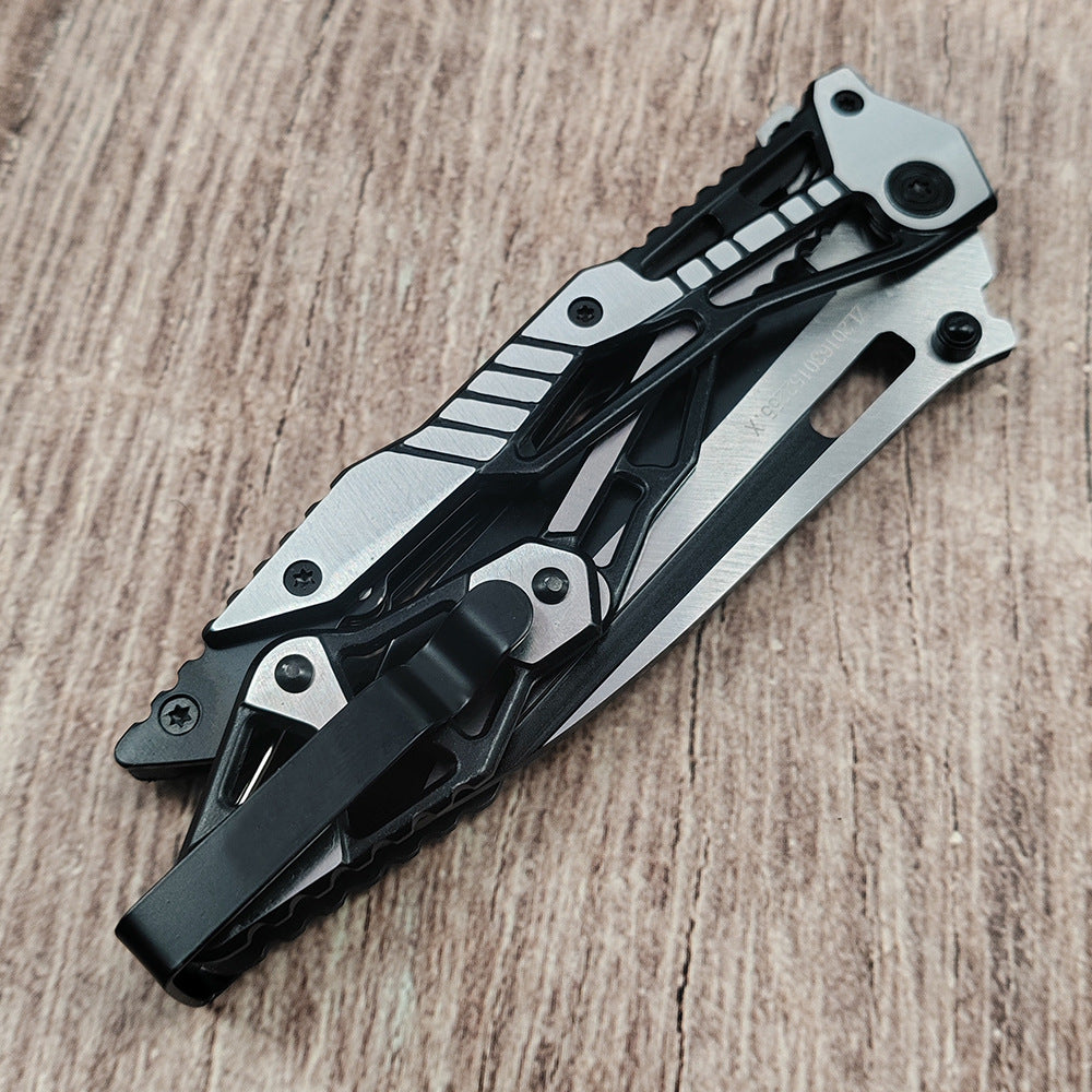 Partially open all-steel folding knife showing blade and skeleton handle on wood surface