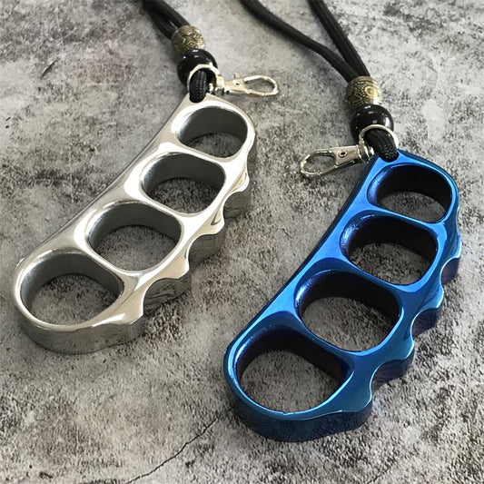 Silver and blue steel knuckle dusters side by side with black cord lanyards, brass beads and lobster clasps on concrete