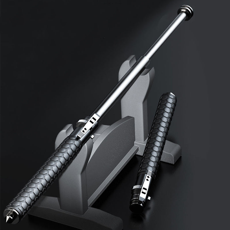 Extended pen-shaped baton resting on a grey display stand beside a closed one with a hexagon-textured handle