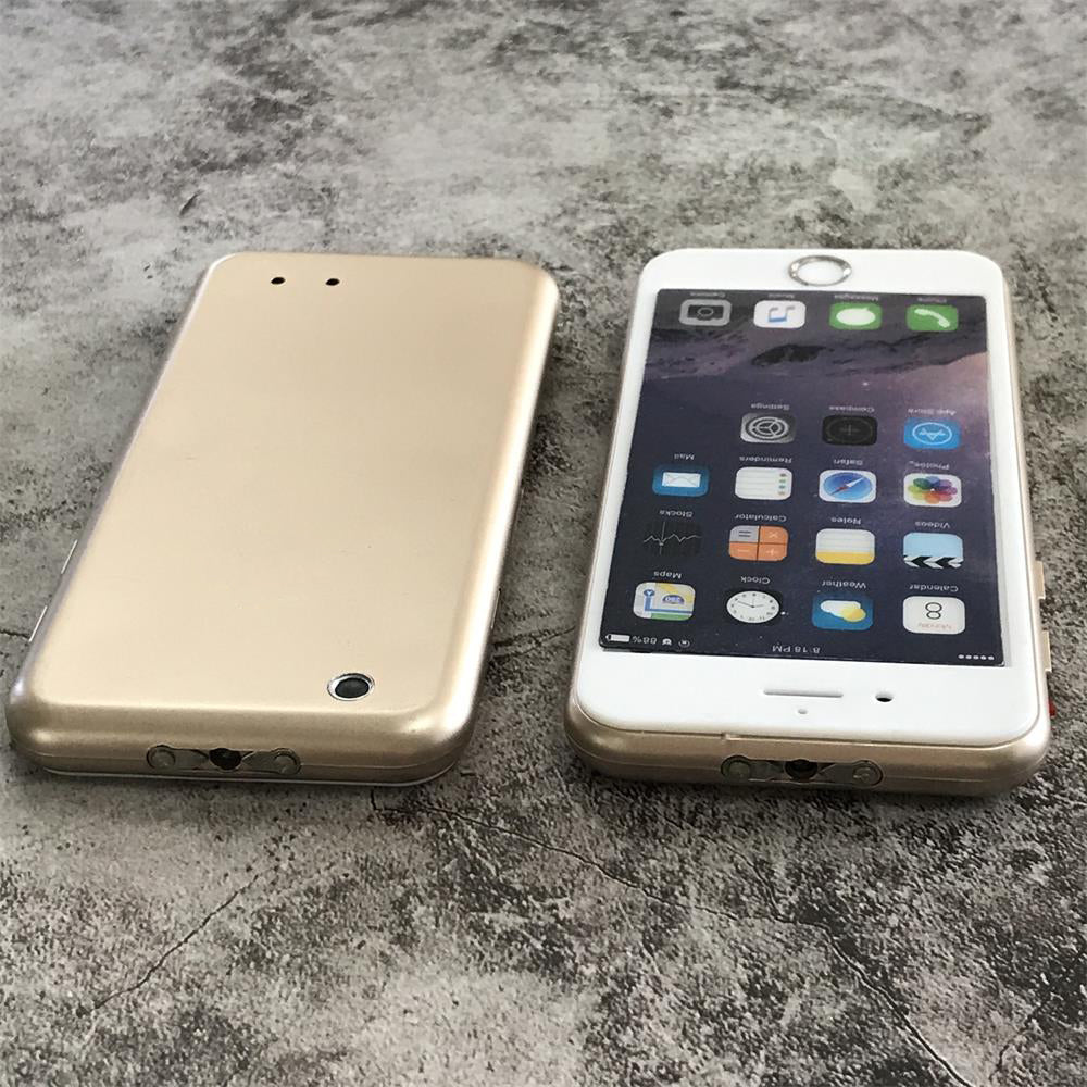 Gold phone-shaped device lying face down beside a white smartphone for size comparison on gray concrete