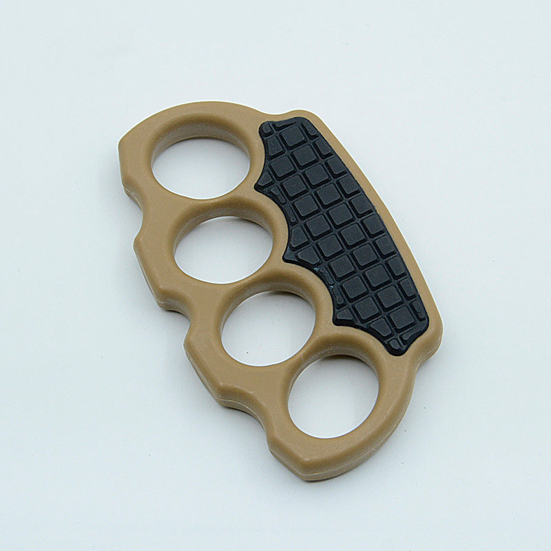 Black, red-black and pink knuckle dusters laid out on a laser-cut panel beside a backpack