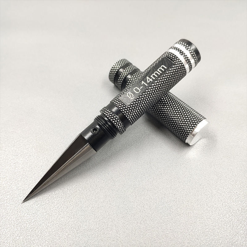 Tapered hole expander resting diagonally on a light gray surface with the aperture marking visible on the handle.