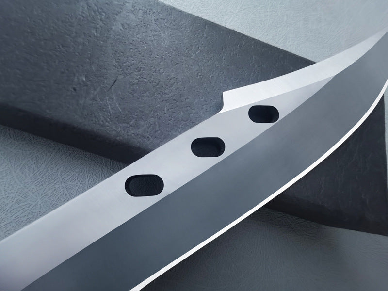 Close-up of folding knife blade with three oval holes and sharp edge