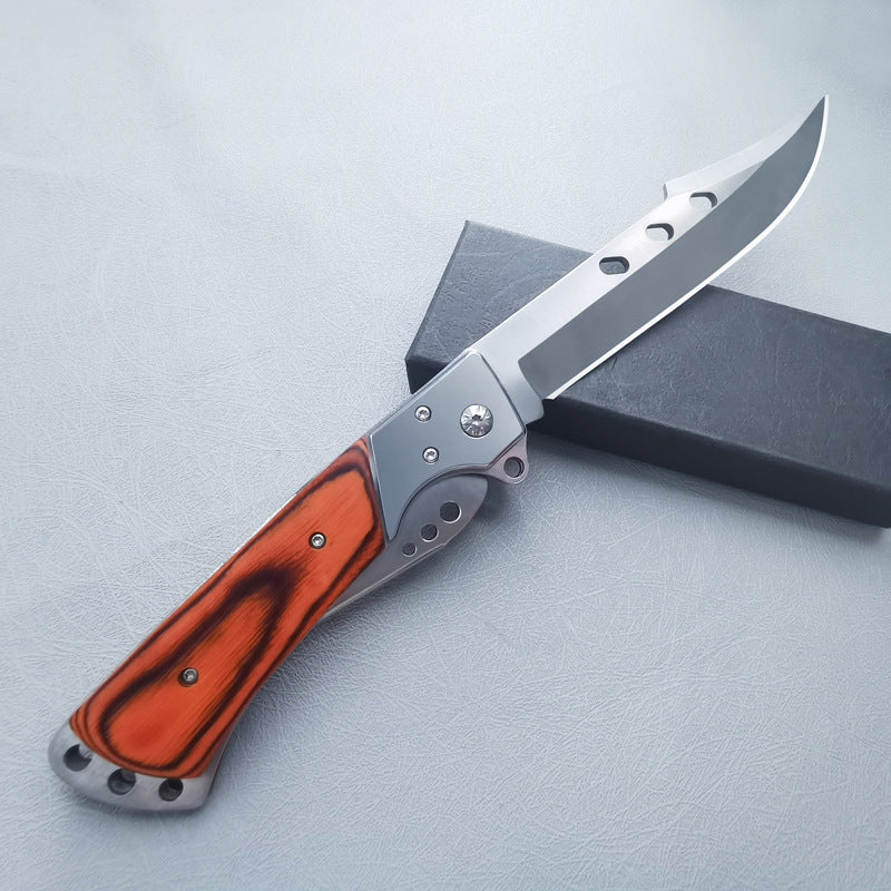 Large redwood handle folding knife partially open showing blade and silver frame