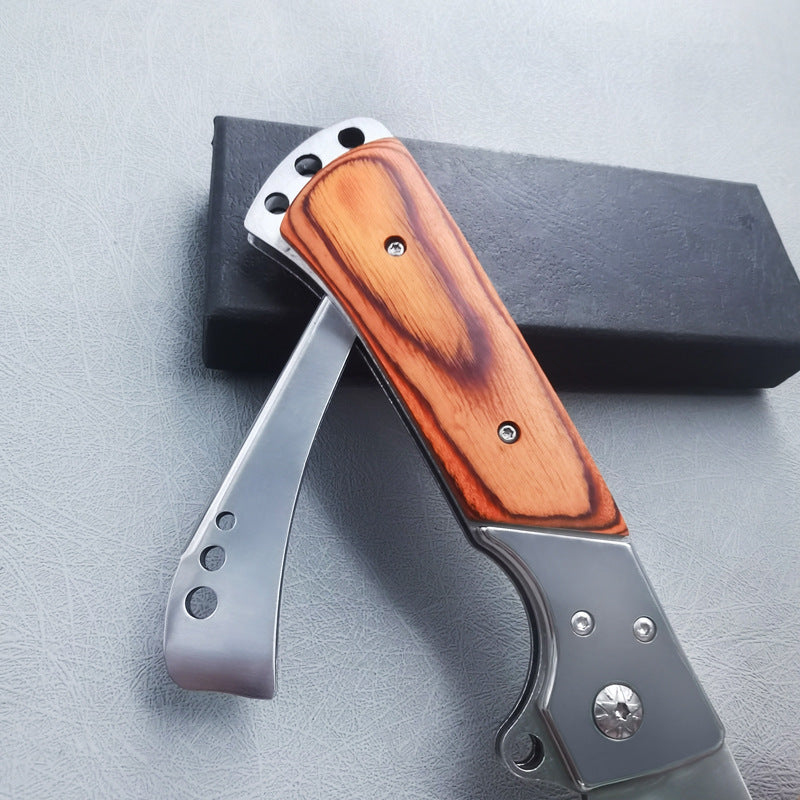 Closed redwood folding knife side profile showing handle thickness and silver frame