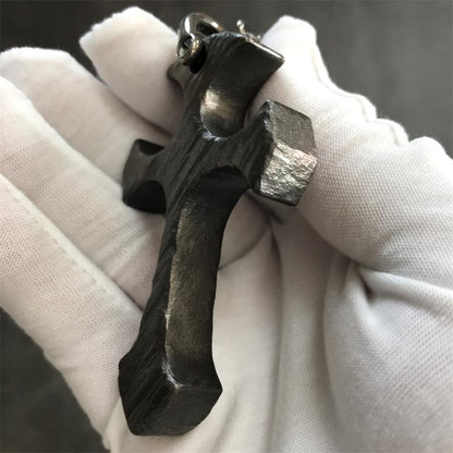 Side profile of Relic finish titanium cross pendant showing stonewashed brushed texture and thickness