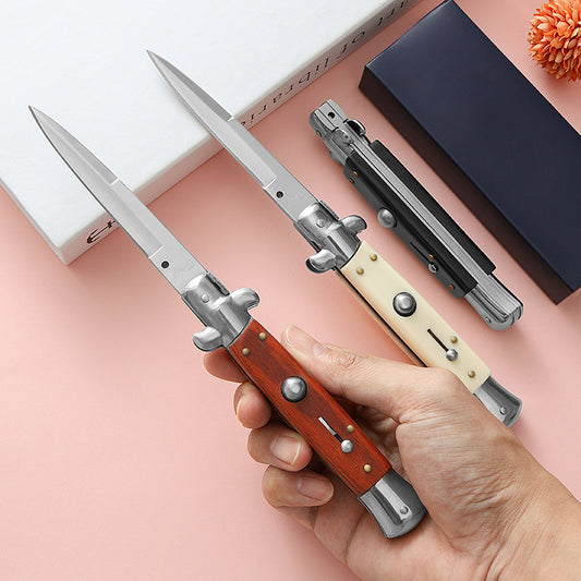 Classic style folding knife with reddish wood handle shown with box and closed knife