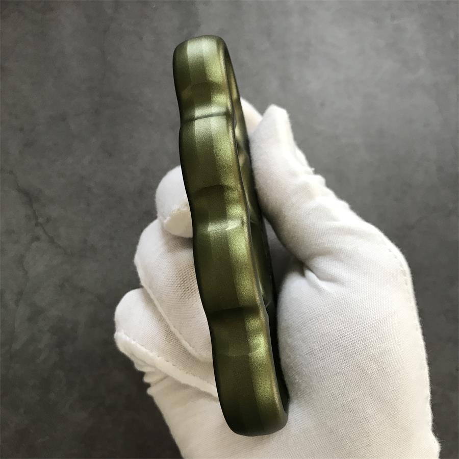 Full side profile showing scalloped silhouette of olive duster