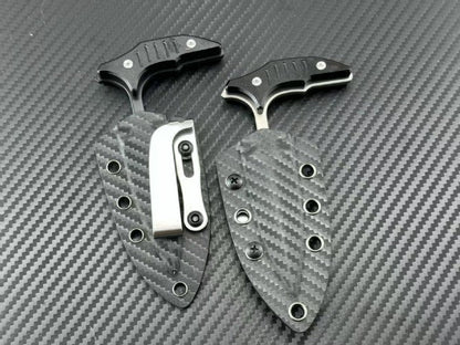 Two push daggers in carbon fiber sheaths showing metal belt clips on reverse side