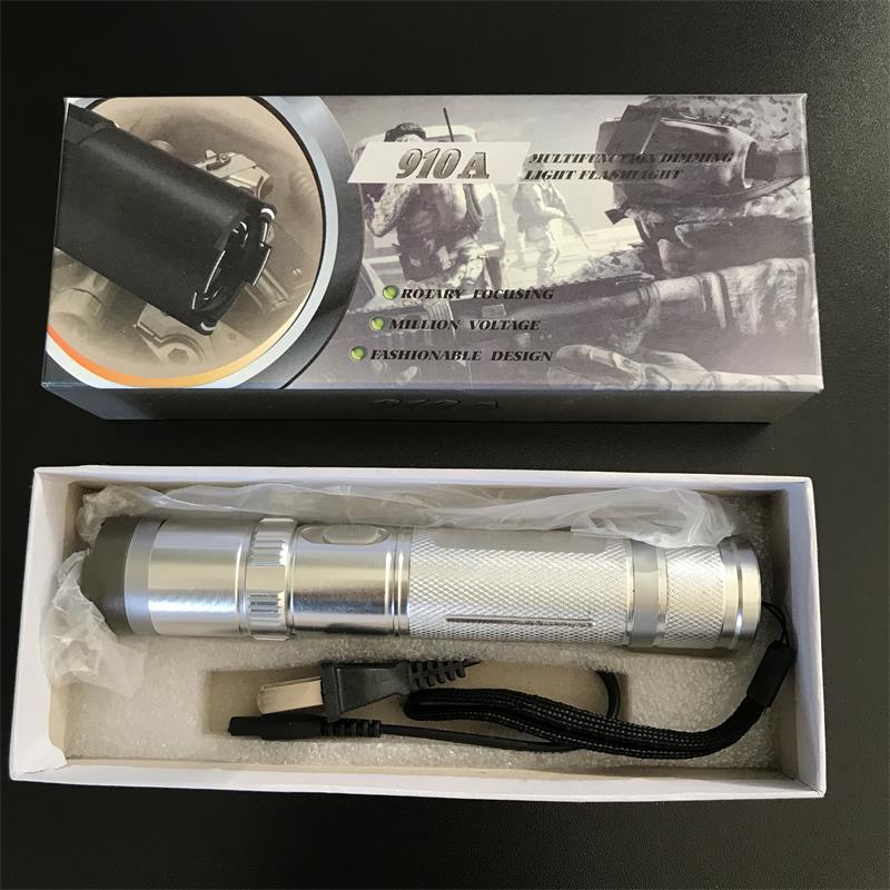 Silver 910A unit plastic-wrapped in the white inner tray with the wall charger and wrist strap below the printed box lid