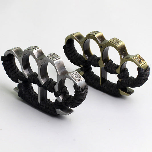 Silver and bronze four-finger knuckle dusters with black paracord grips on white background