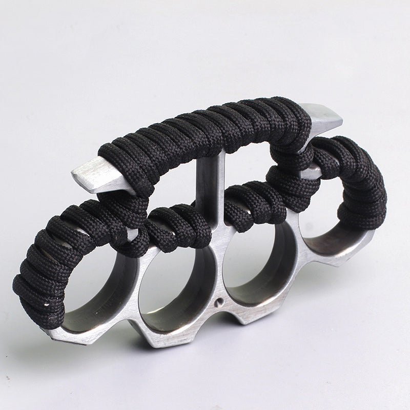 Silver three-hole knuckle duster side view showing paracord grip on white background