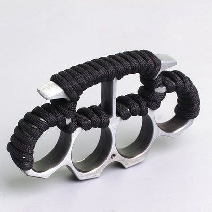 Silver three-hole knuckle duster side view showing paracord grip on white background