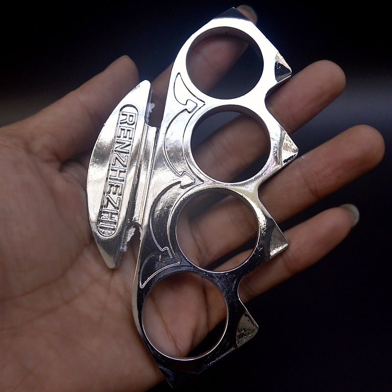 Silver knuckle duster resting in an open palm with the raised palm plate facing up