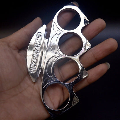 Silver knuckle duster resting in an open palm with the raised palm plate facing up