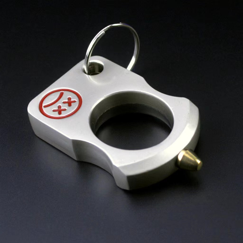 Brushed silver single-hole zinc alloy knuckle keychain with red cartoon face print and steel split ring on a dark background