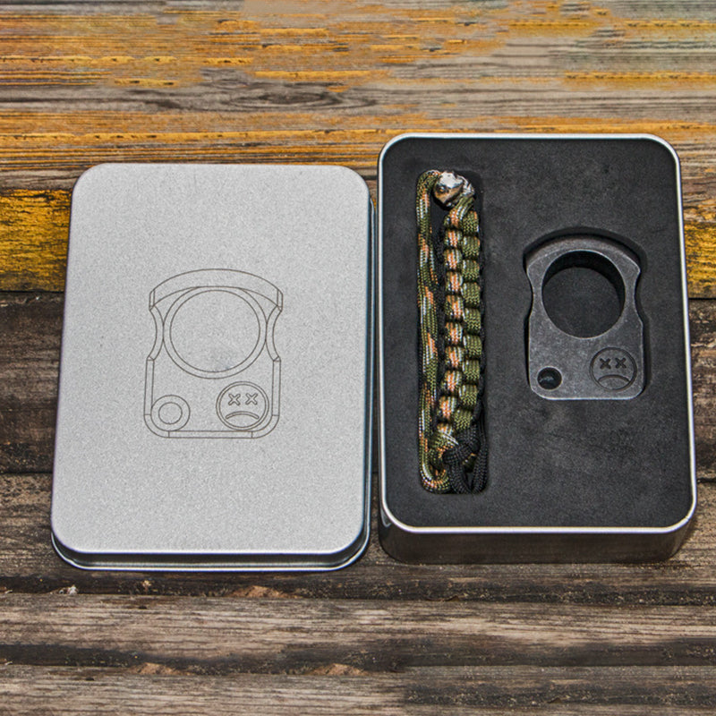 Light and dark single-hole knuckle weights on a granite surface beside black paracord, with 3Cr13 text in the corner