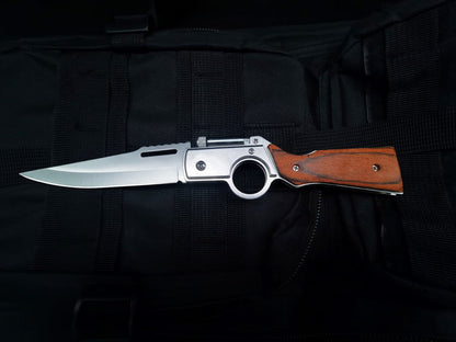 Single open wood-handle folding knife on black tactical fabric