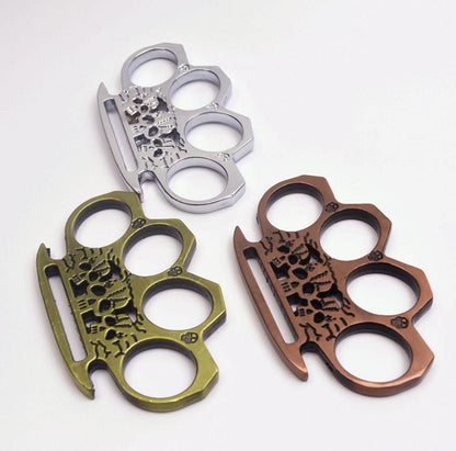 Skeleton knuckle dusters in silver, bronze and rose gold arranged on a white background