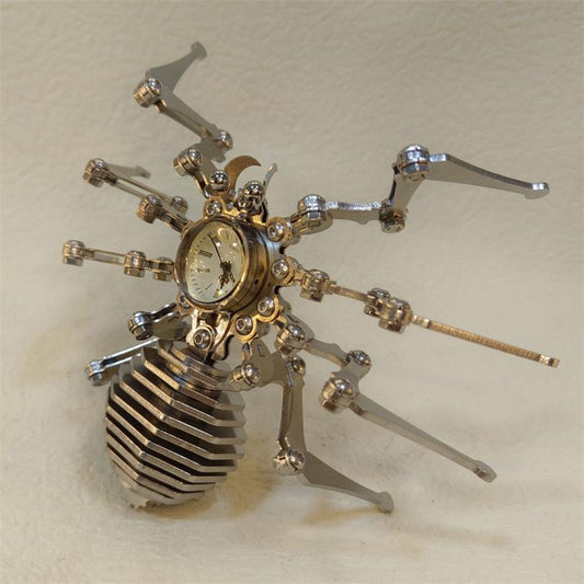 Top-down view of stainless steel spider figurine with eight jointed legs spread wide on a cream background