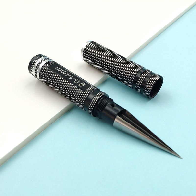 Step drill bit paired with its black knurled storage case and detached cap on a split white and blue background.