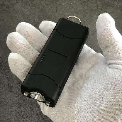 Black 801C stun gun laid out with its nylon belt holster and charging cable