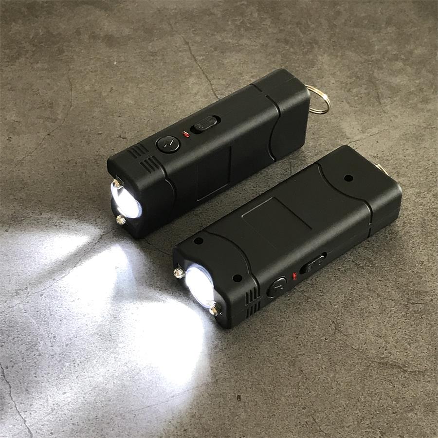 Black 801C stun guns with the lighting function switched on casting bright white beams