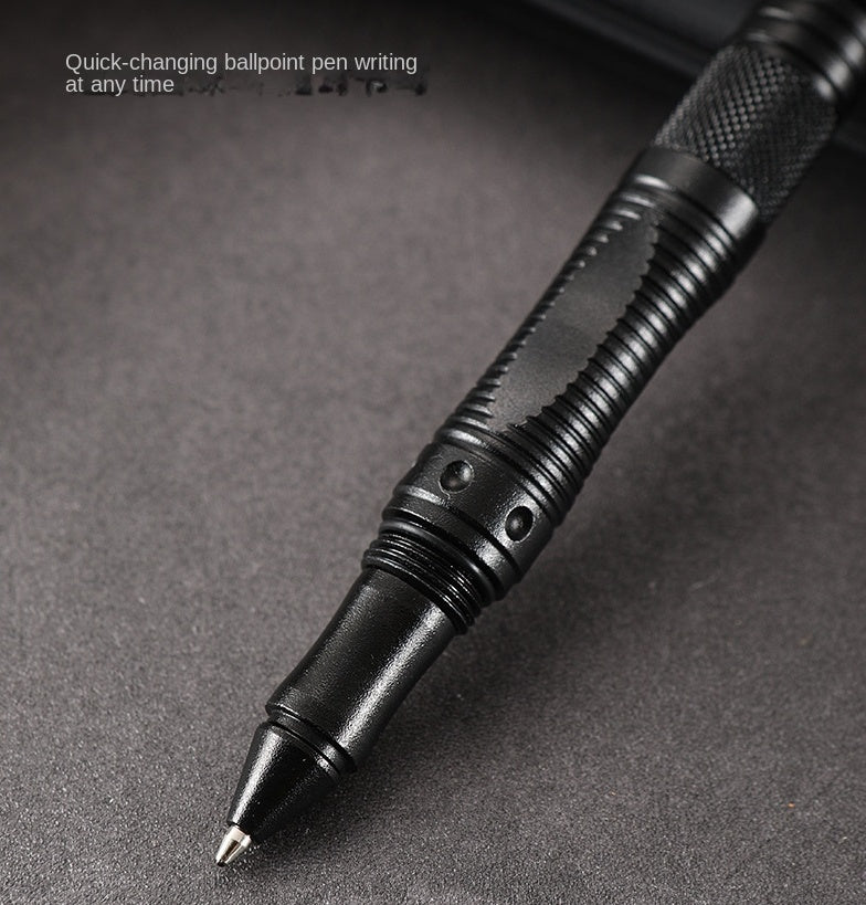 Close-up of the black tactical pen's ballpoint tip with a knurled grip and a double-collar band above it, captioned Quick-changing ballpoint pen writing at any time.