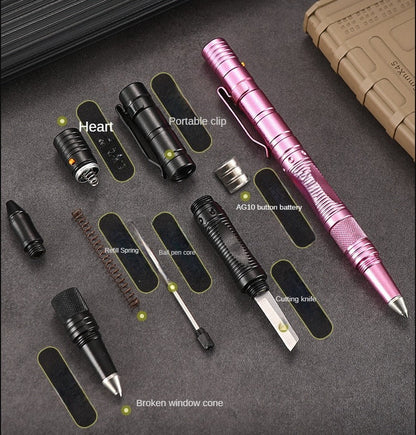 Exploded parts view of the tactical pen on a dark surface showing its LED head with an orange button, pocket clip, AG10 button battery, refill spring, ballpoint refill, a small cutting knife and a knurled broken-window cone, with a pink assembled pen at the right and a tan pouch above.