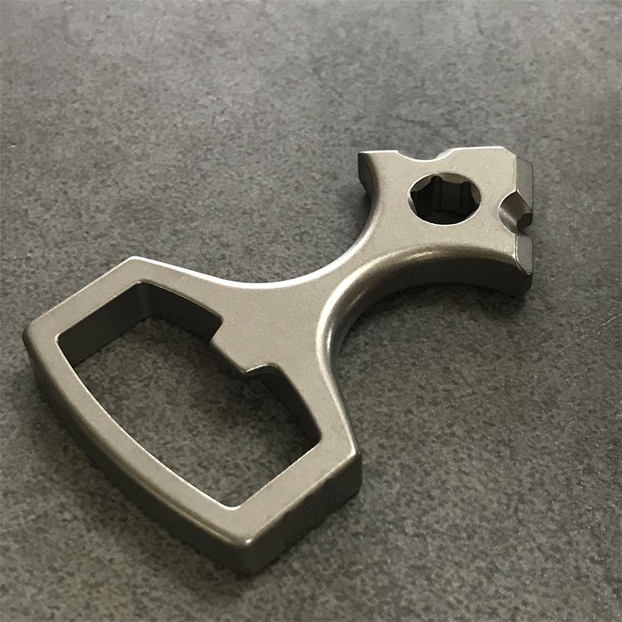 Close view of the tapered head of the titanium tool showing the hex socket and notched shoulders