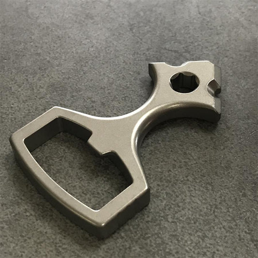 Close view of the tapered head of the titanium tool showing the hex socket and notched shoulders