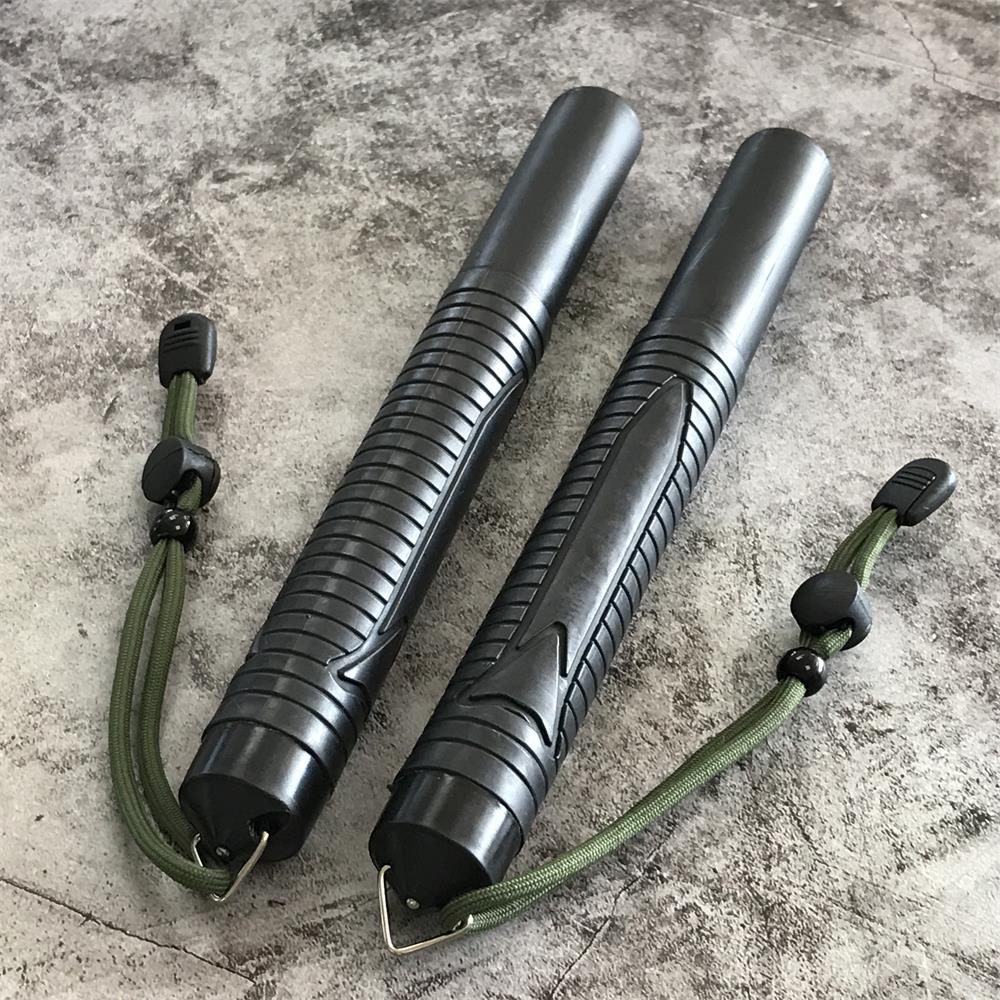 Two collapsed batons on concrete with the smooth front caps facing out
