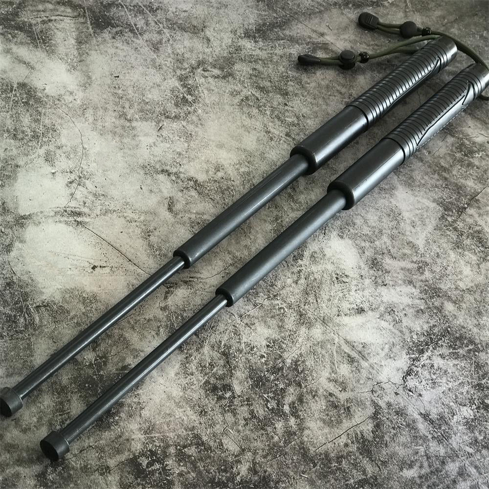 Two batons fully extended on concrete showing the three-section shafts
